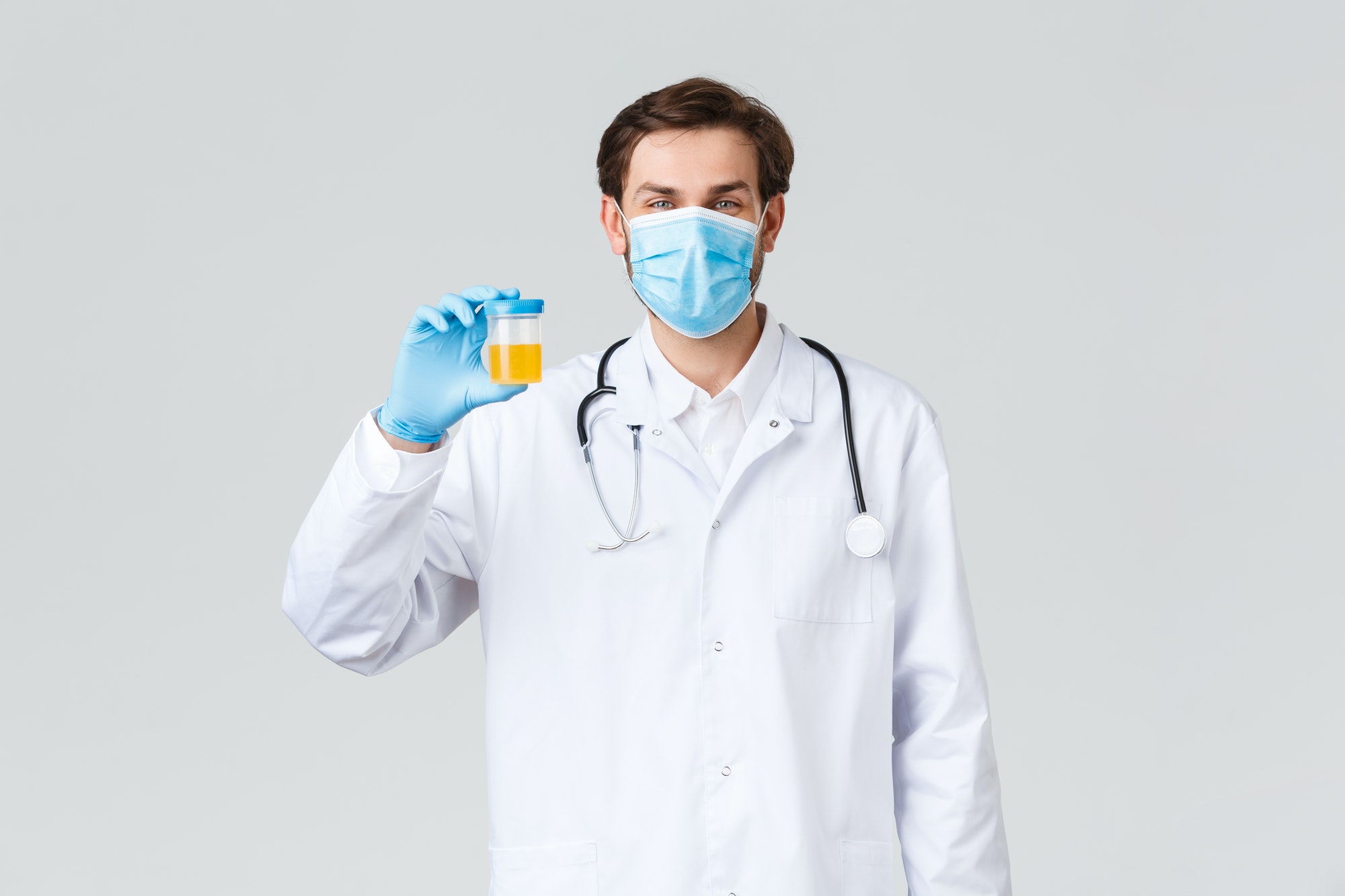 Hospital, healthcare workers, covid-19 treatment concept. Smiling optimistic doctor in white scrubs